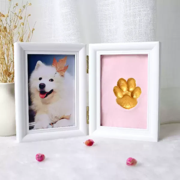 Dog licking owner near paw print frame